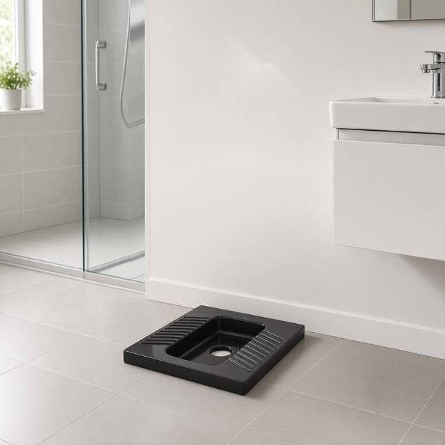 Black Morvarid Yaris squat toilet in a modern bathroom, front-right view